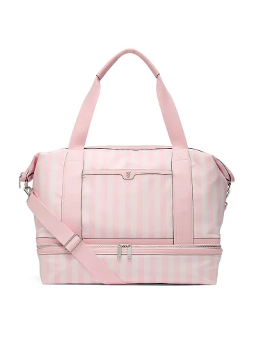 Victoria's Secret siganture stripes Weekender bag on a light grey background.